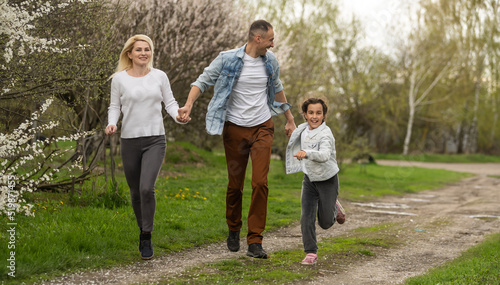 Young family with children and with dog having fun in nature