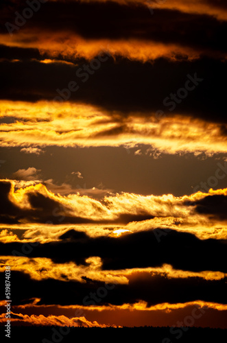 Sunset. When the sun, so close, big, crimson red, fantastically beautiful, saying goodbye to a summer day, gently gives the last warm rays.