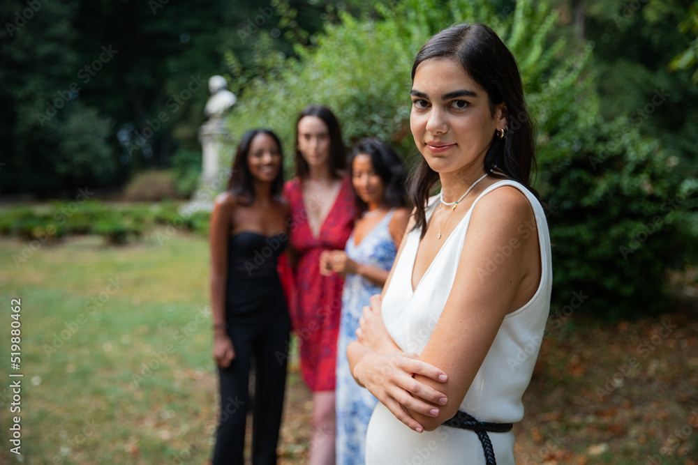 Close-up of an isolated caucasian girl with her friends of different ethnicities in the background, concept of women and diversity. Close-up of an isolated caucasian girl with her friends of different ethnicities in the background, concept of women and diversity.