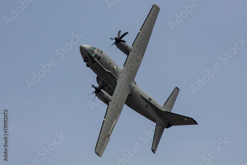 Grey Military Transporter Turboprop Aircraft in steep high angle of attack roll 