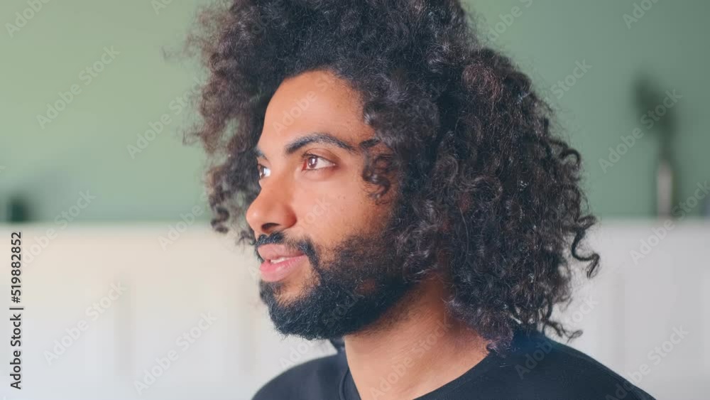 Close up young cheerful millennial middle eastern man with black curly