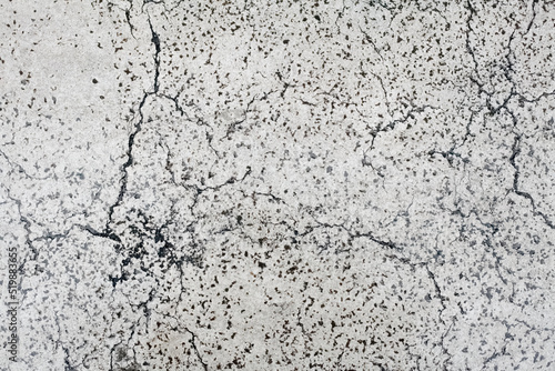 A concrete wall backdrop or texture, with cracks and damages. Old, worn, aged surface, still flat.
