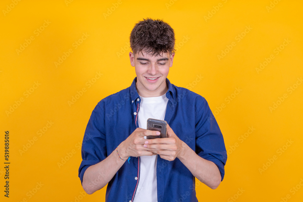 young man with mobile phone isolated on background young man with mobile phone isolated on background