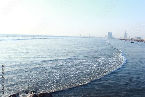 A beautiful picture of seaview wave with buildings karachi sindh. peoples of karachi. photo