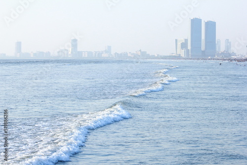 A beautiful picture of seaview wave with buildings karachi sindh. peoples of karachi.