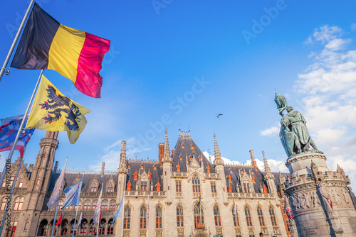 Fototapeta Belgian and euro flags, flemish architecture in Bruges market square