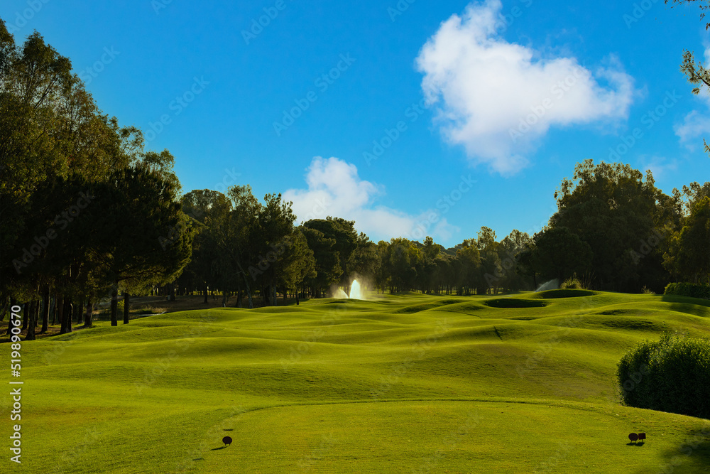 Golf course serenely under a beautiful sky