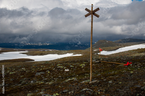 Snow patches on a hiking trail to Sylarna Mountain Station in the rain, July, Jamtland, Sweden photo