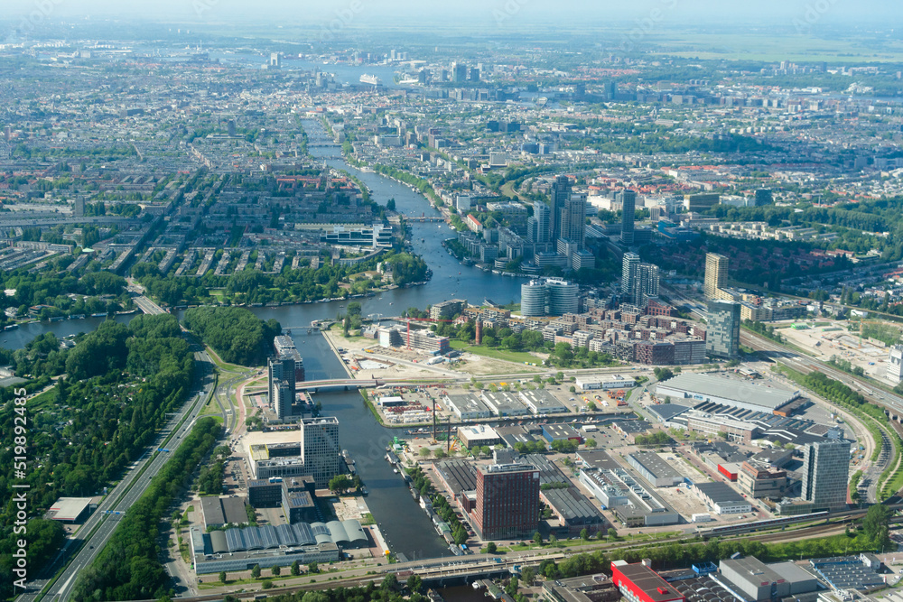 Aerial view of marshlands, modern city and skyscrapers from airplane Aerial view of marshlands, modern city and skyscrapers from airplane