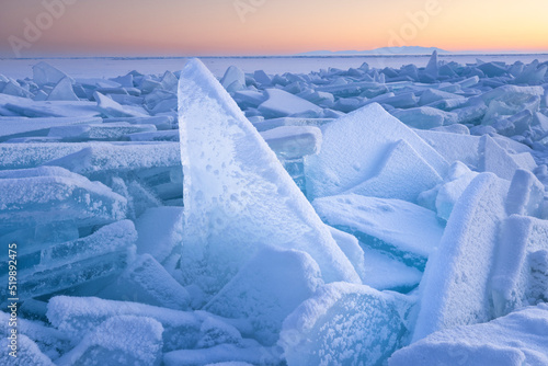 snowed blocks of clear ice ar sunrise photo