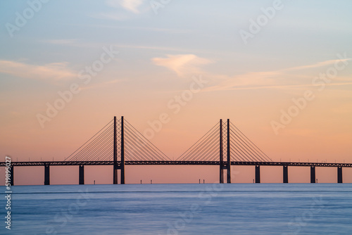 The Oresund Bridge is a combined motorway and railway bridge between Sweden and Denmark (Malmo and Copenhagen). Long exposure. Selective focus. photo