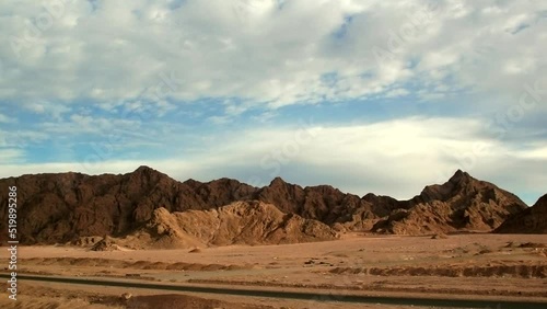 Car highway in the middle of the Sinai desert. Beautiful Egyptian mountains and blue sky. Landscapes of the Senai Peninsula