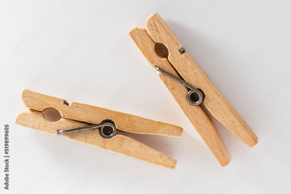 Two wooden clothespins on a white background Two wooden clothespins on a white background