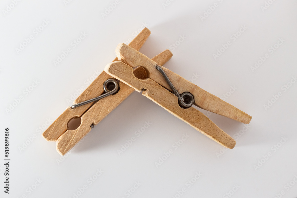 Two wooden clothespins on a white background Two wooden clothespins on a white background
