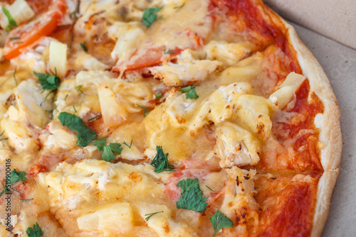 Pizza with pineapple, chicken, tomatoes and cheese