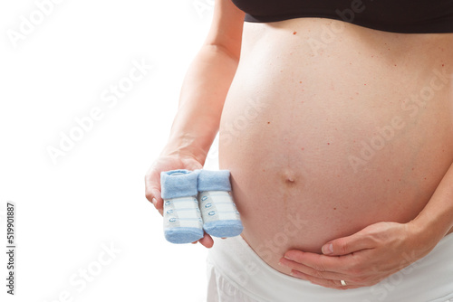 Pregnant woman holding small blue baby socks