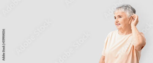 Senior woman with hearing a...