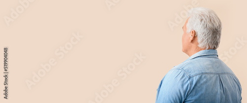 Mature man with hearing aid...