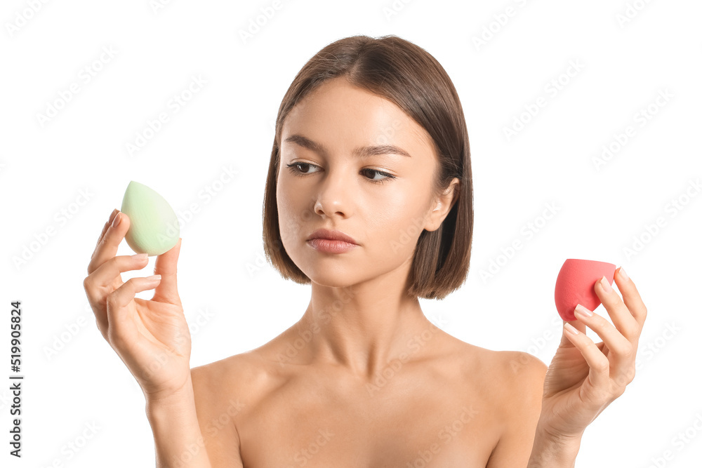 Pretty young woman with makeup sponges on white background Pretty young woman with makeup sponges on white background