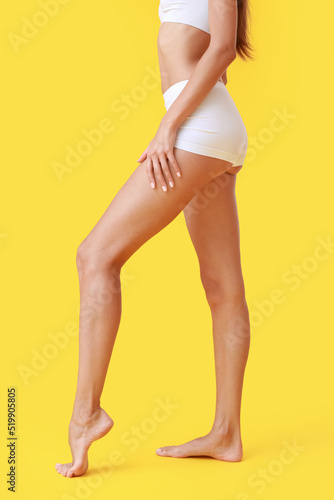 Young tanned woman on yello...
