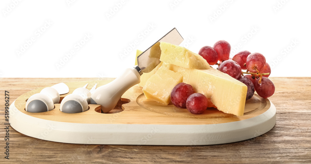 Wooden board with pieces of tasty Parmesan cheese and grape on table against white background