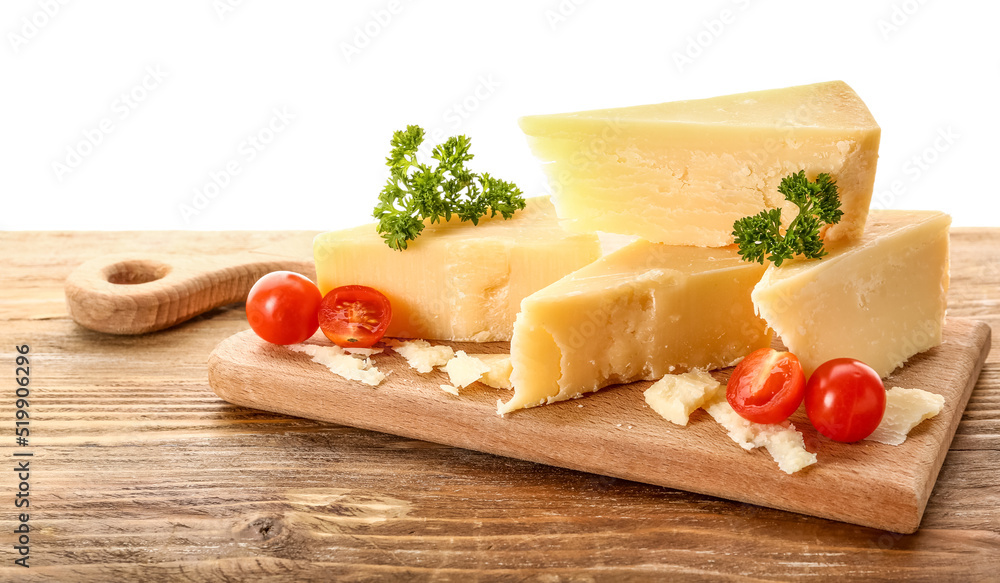 Wooden board with pieces of tasty Parmesan cheese on table against white background Wooden board with pieces of tasty Parmesan cheese on table against white background