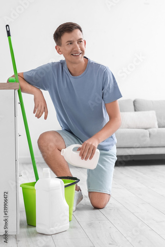 Young man pouring detergent...