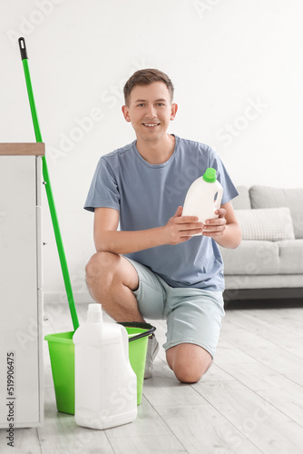 Young man with bottle of de...