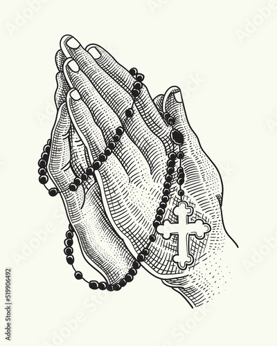 praying hands with a rosary necklace
