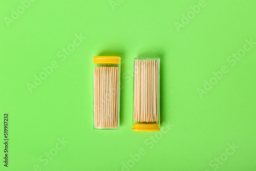 Holders with toothpicks on green background © Pixel-Shot