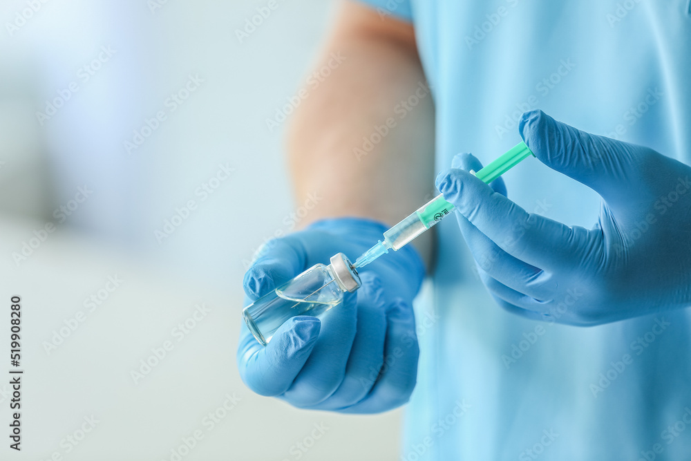 Doctor with ampule and syringe in clinic, closeup Doctor with ampule and syringe in clinic, closeup
