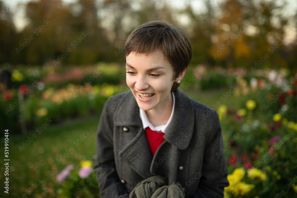 Beautiful teenage girl in blossoming dahlia field. Child picking fresh flowers in dahlia meadow on sunny autumn day. Beautiful teenage girl in blossoming dahlia field. Child picking fresh flowers in dahlia meadow on sunny autumn day.