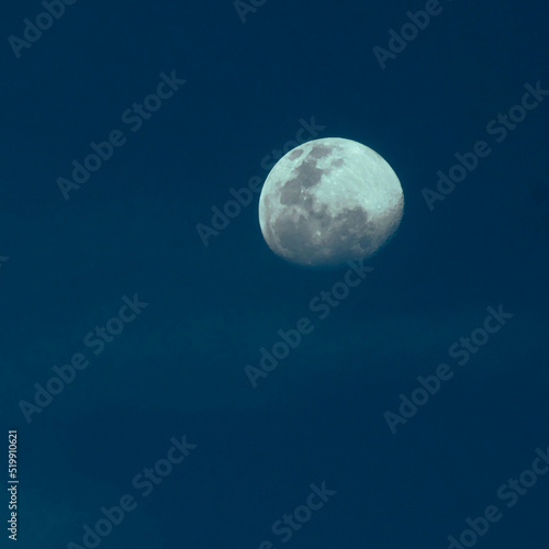 Image of the moon isolated over dark blue sky background.