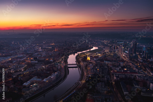 Scenic aerial view of Vilnius Old Town and Neris river at nightfall. Sunset landscape. Vilnius, Lithuania.