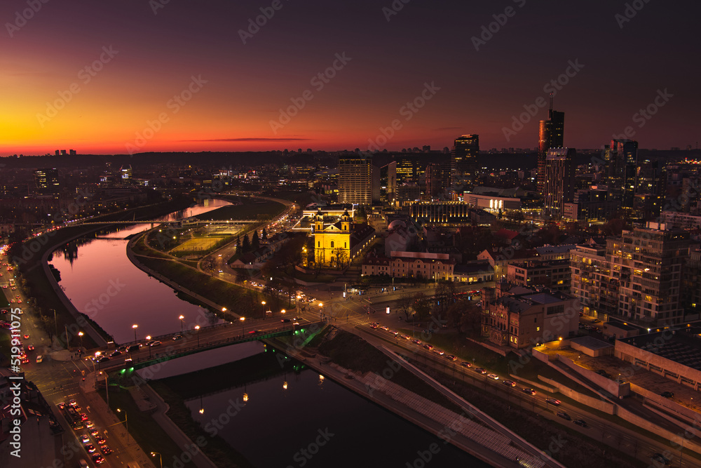 Scenic aerial view of Vilnius Old Town and Neris river at nightfall. Sunset landscape. Vilnius, Lithuania.