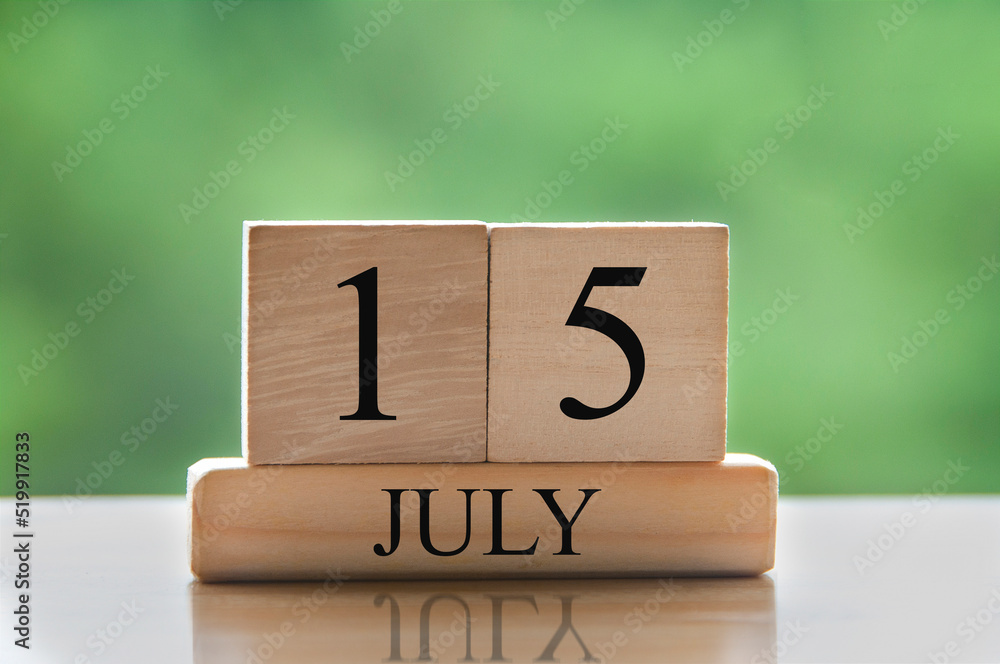 July 15 calendar date text on wooden blocks with blurred background park. Calendar concept July 15 calendar date text on wooden blocks with blurred background park. Calendar concept