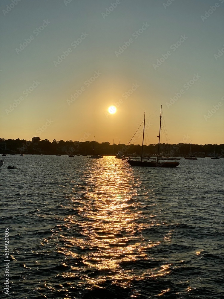 Setting Sun on the Horizon With a Boat in the Water