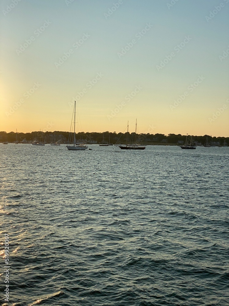 Setting Sun on the Horizon With a Boat in the Water Setting Sun on the Horizon With a Boat in the Water