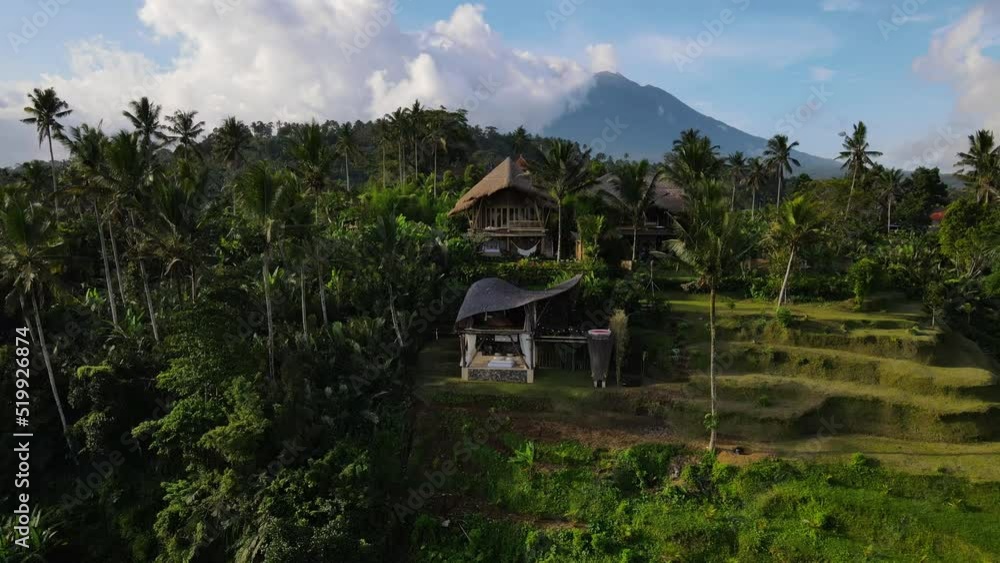 Aerial view of Balinese Eco House and Mount Agung volcano with clouds Aerial view of Balinese Eco House and Mount Agung volcano with clouds
