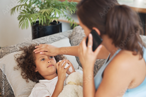 Cuadro en lienzo Healthcare, family and sick little child suffering from fever, flu and cold and mother checking temperature of her ill son while calling a doctor
