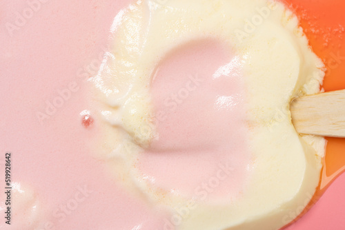 top view cats paw shape peach and cheese flavor popsicle melted on pink close up