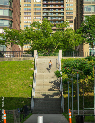 A solo runner ascends a long flight of steps