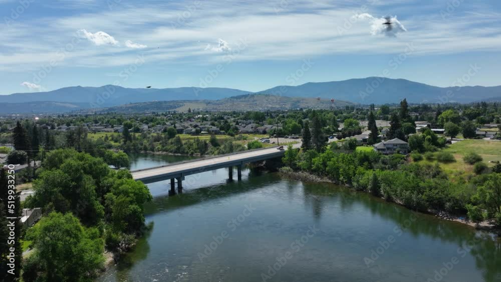 Aerial shot pushing towards a bridge over the Spokane River with birds flying through the shot. Aerial shot pushing towards a bridge over the Spokane River with birds flying through the shot.