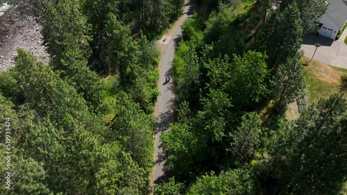 Top down aerial shot of cyclists riding along the Spokane River Centennial State Park Trail. photo