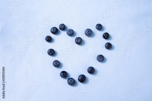 Blueberry heart on purple background
