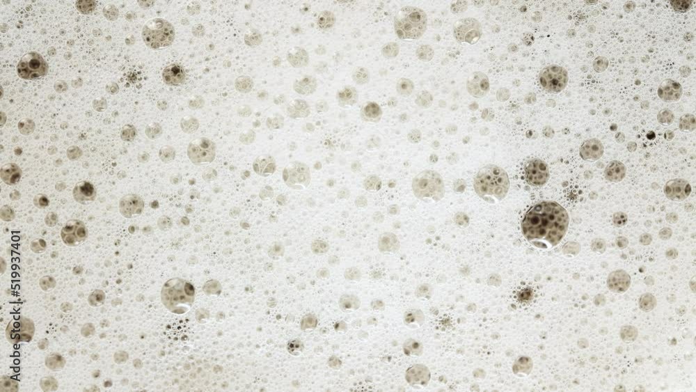 Popping bubbles of a beer foam. 4k mscro video footage Popping bubbles of a beer foam. 4k mscro video footage