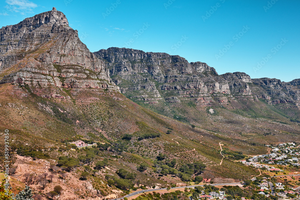 Beautiful, relaxing and calming panoramic view of Table mountain in Cape Town, South Africa. Banner of lush green bushes and trees growing on rocky peaks with trails and scenic views of the city