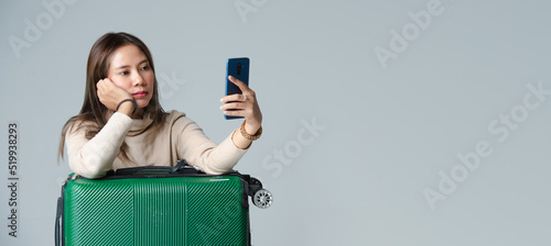 Women with luggage go on vacation weekend You can see attractions on your mobile phone. journey concept isolated background gray