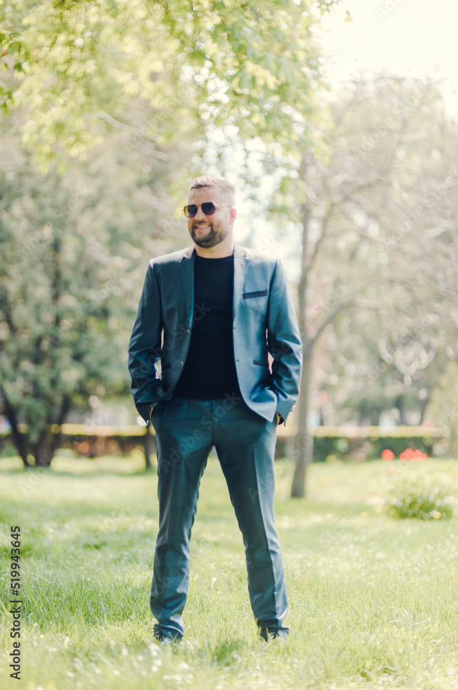A stylish man in black glasses and a business suit is waiting for a meeting. A stylish man in black glasses and a business suit is waiting for a meeting.