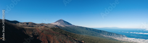 Panorama of caldera in Teide National Park  Tenerife  Canary Islands  Spain. Roques de Garcia in the foreground and snow covered mount Pico del Teide in the background.